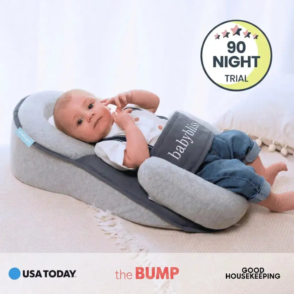 Baby lying on a gray baby lounger with 'babylo' branding, surrounded by USA Today, the Bump, and Good Housekeeping logos.
